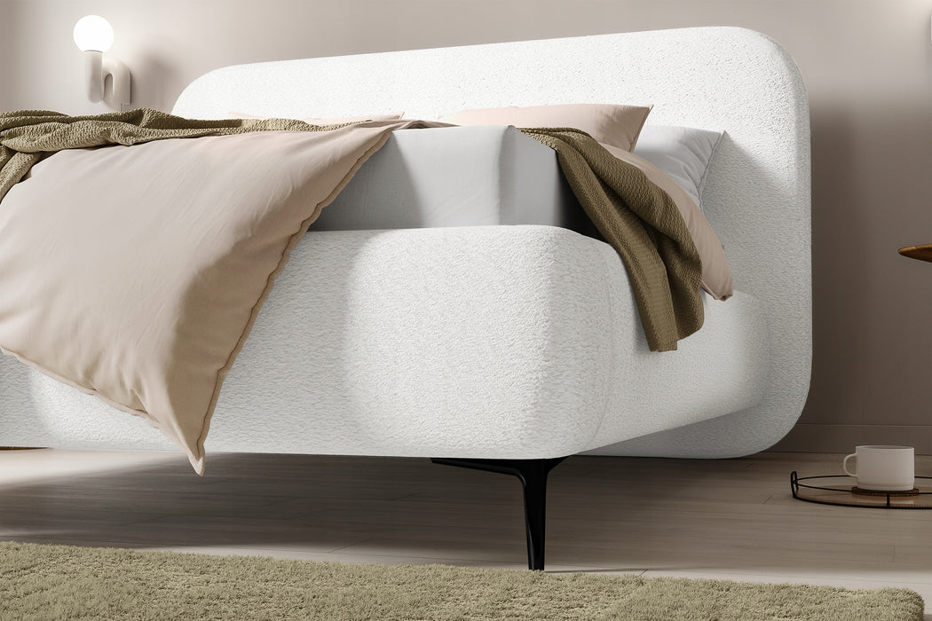 The bed is covered with boucle fabric