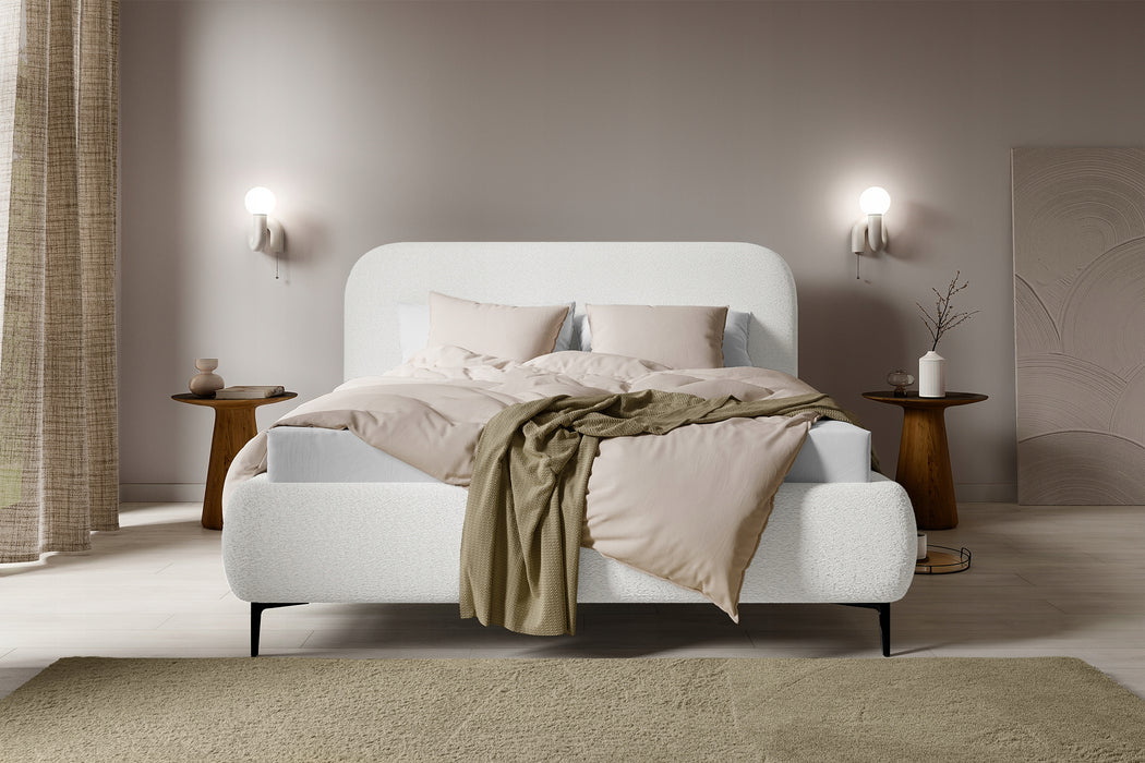 The bed is covered with boucle fabric