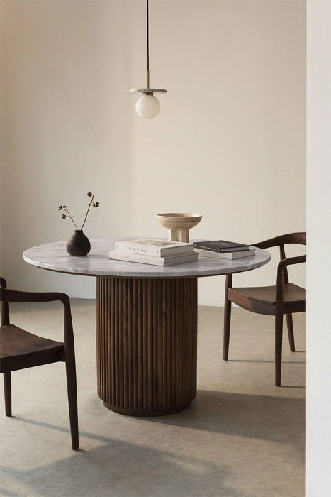 Round dining table made of natural stone and mango wood Giselda
